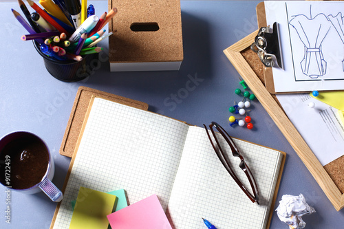 Desk of an artist with lots of stationery objects. Studio shot