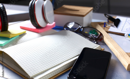 Desk of an artist with lots of stationery objects. Studio shot