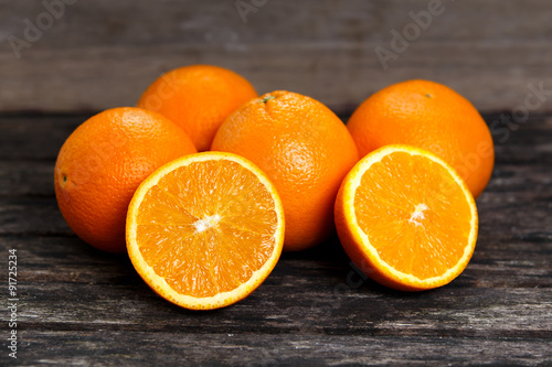 Beautiful Oranges Fruit Full and Sliced on old wooden table. rich with vitamins. background, texture