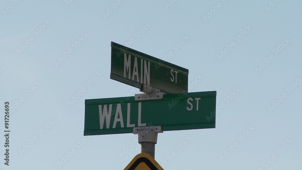 A street sign indicates the intersection of Main and Wall Streets. A street sign indicates the intersection of Main and Wall Streets.