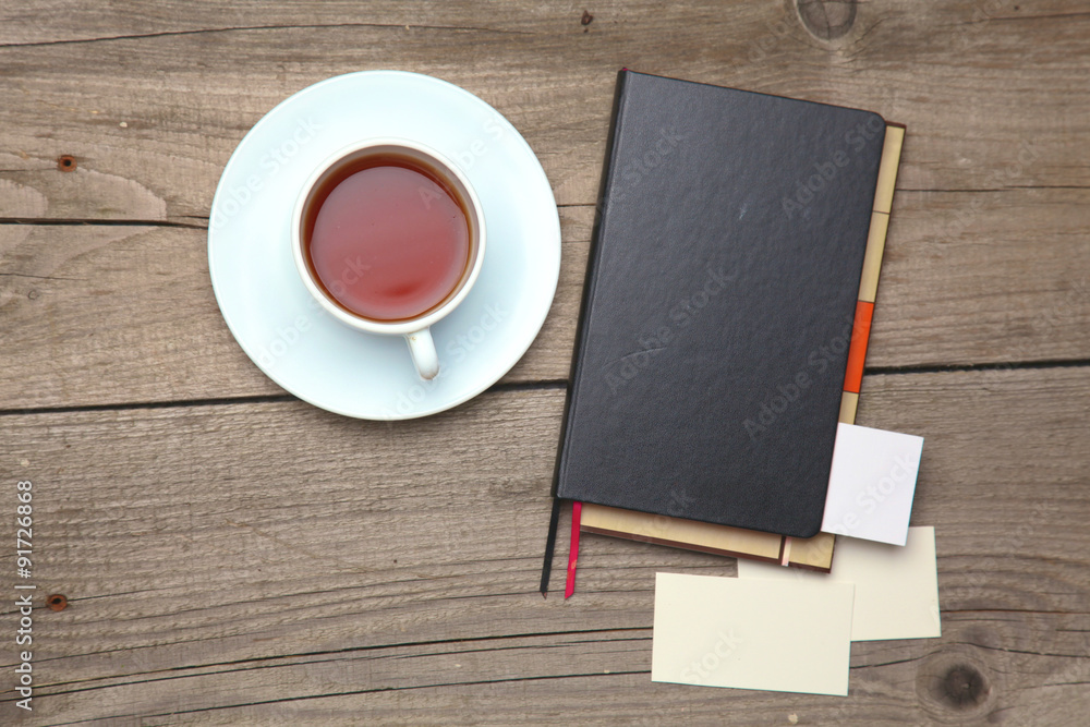 Blank business cards with pen, notebook and tea cup on wooden Blank business cards with pen, notebook and tea cup on wooden