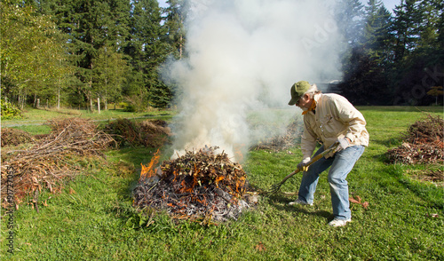 Man Feeding an Outdoor Fire