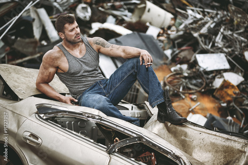 The man taking a rest on a car wreck © fotorince
