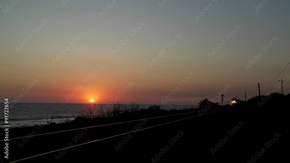 Beautiful shot of an Amtrak train passing by a California beach at sunset. Beautiful shot of an Amtrak train passing by a California beach at sunset.