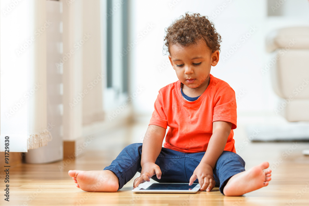 African american little boy using a tactile tablet African american little boy using a tactile tablet