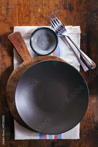 empty black bowl on a towel on a wooden texture background. spac