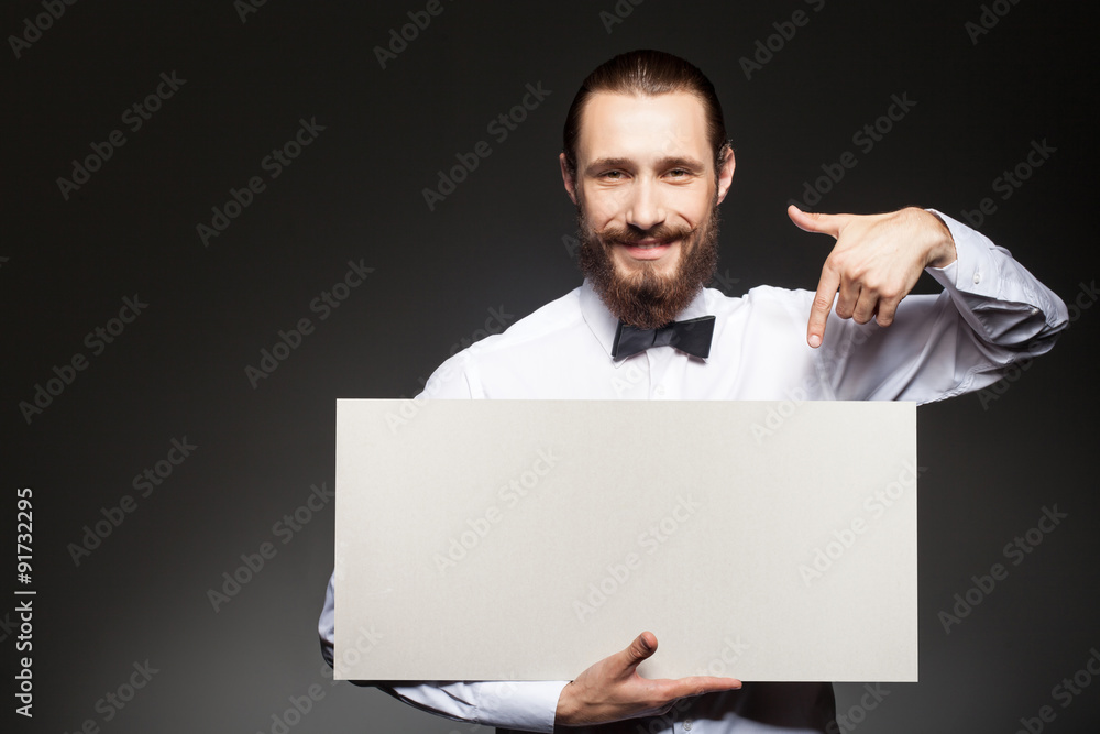 Attractive young guy with beard is carrying placard Attractive young guy with beard is carrying placard