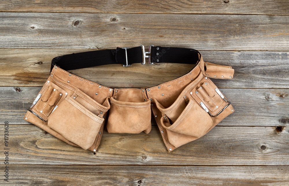 Leather tool belt on rustic wooden boards