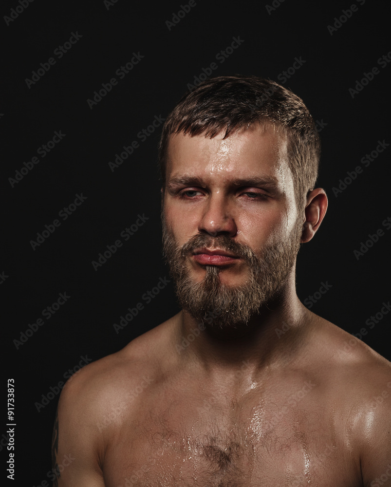 Athletic bearded boxer on a dark background Athletic bearded boxer on a dark background