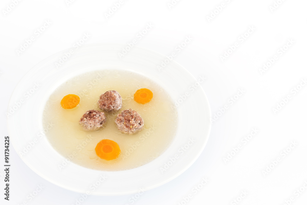 Plate of soup with carrot and meat balls