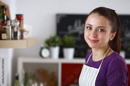 A young woman in the kitchen.