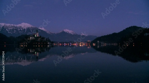 A small church on an island at dawn at Lake Bled, Slovenia. photo