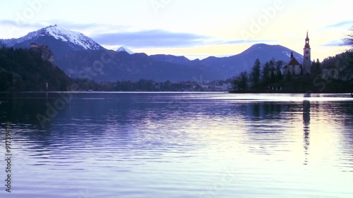 A small church on an island at dawn at Lake Bled, Slovenia. photo