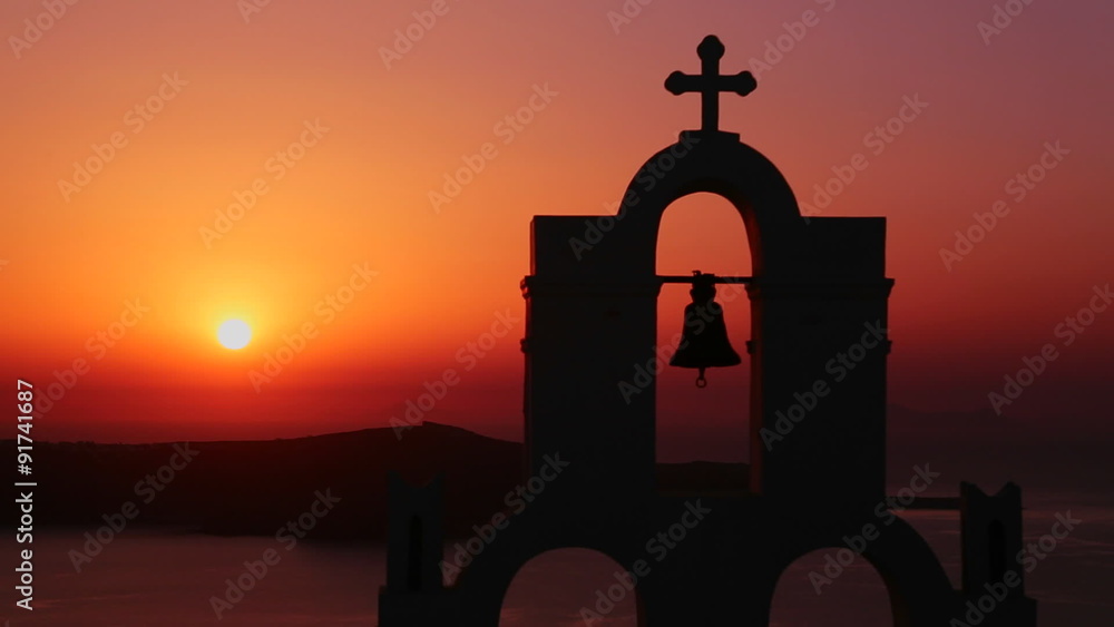 An amazing and beautiful sunset behind a Greek Orthodox Church on the Greek Island of Santorini. An amazing and beautiful sunset behind a Greek Orthodox Church on the Greek Island of Santorini.