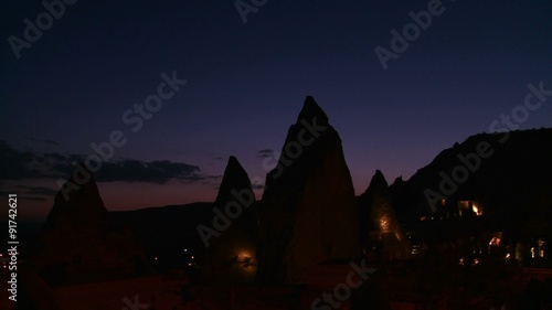 Strange spires are silhouetted at dusk at Cappadocia, Turkey. photo