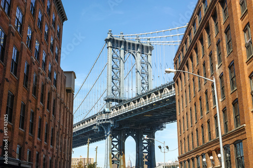 New York City Manhattan Bridge and brick wall buildings
