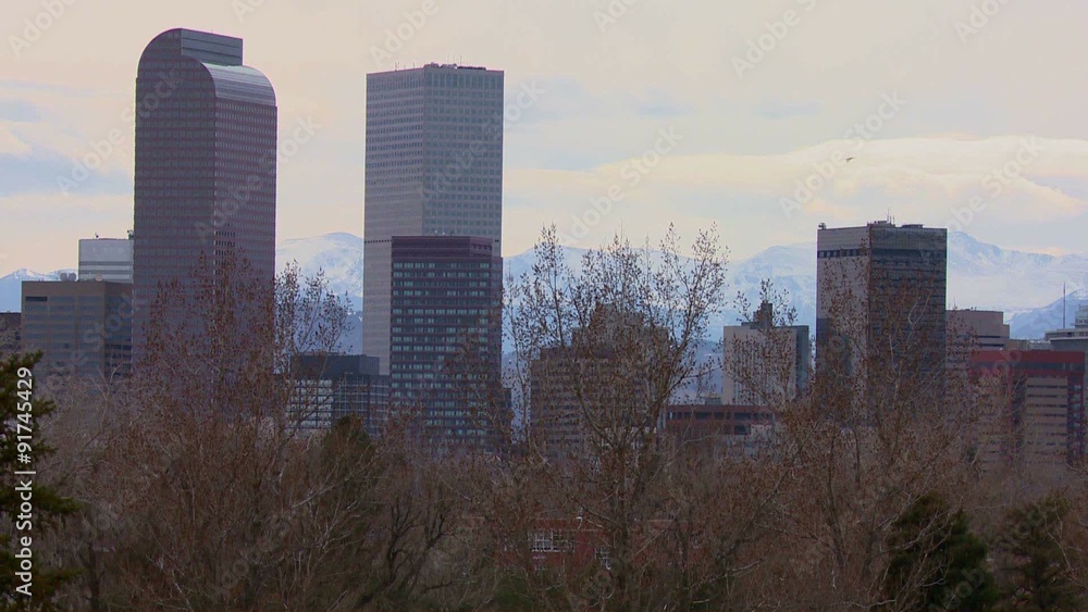 The Denver Colorado skyline in beautiful light with bikers and joggers passing. The Denver Colorado skyline in beautiful light with bikers and joggers passing.