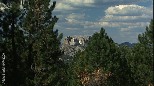 WS Mt. Rushmore through trees, slow ZM in photo
