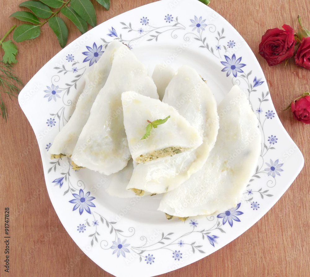 Traditional vegetarian dish made from rice flour dough with spicy filling. Traditional vegetarian dish made from rice flour dough with spicy filling.