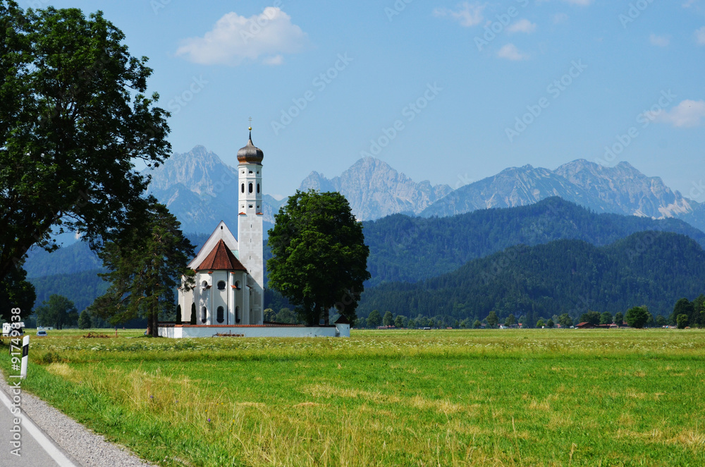 St Coleman's church in upper Bavaria, Germany with spectacular mountains behind