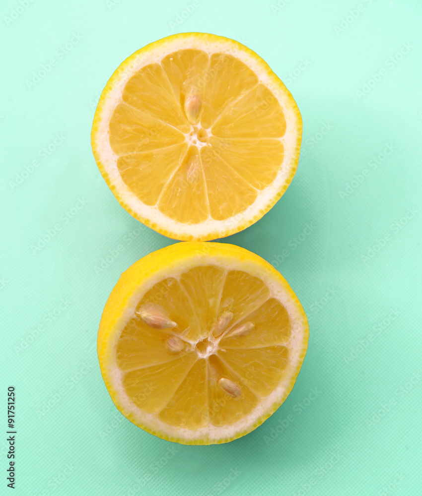 sliced lemon on pastel green background sliced lemon on pastel green background