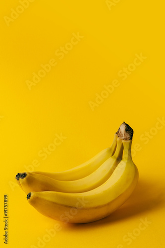 Ripe bananas on the yellow background