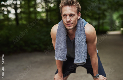 Athletic Man Resting After Jogging at the Park