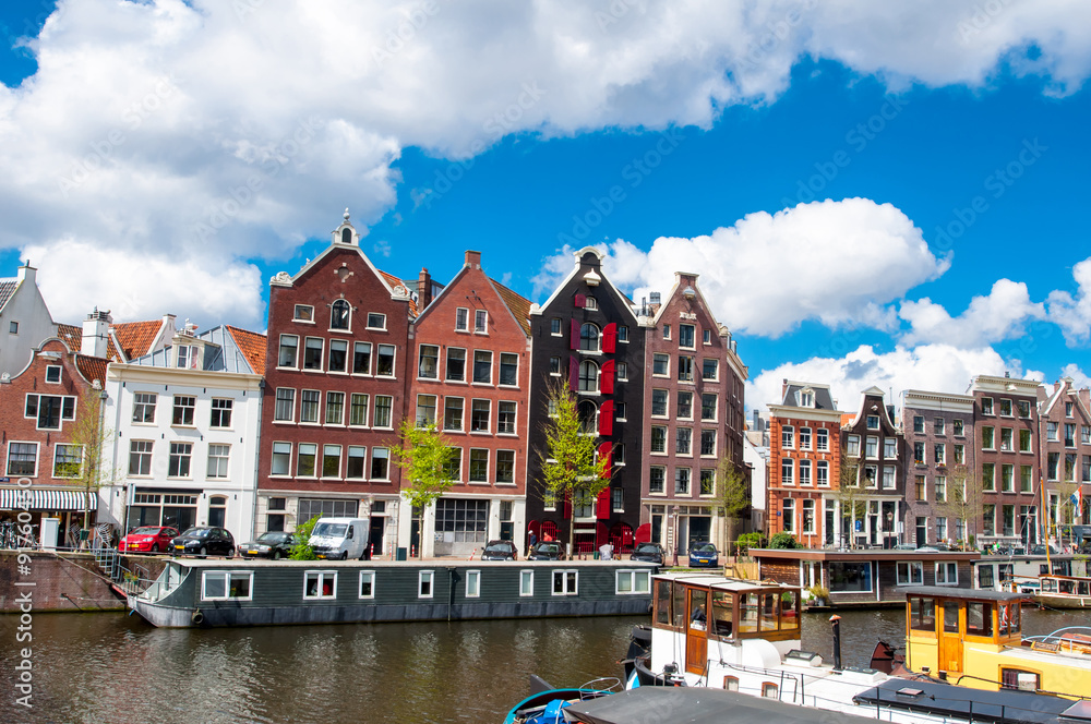Tipical Amsterdam cityscape with apartment houses in down town. The Kingdom of the Netherlands.