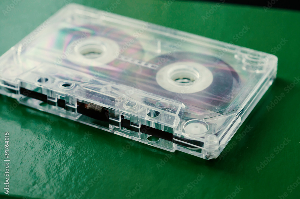 Old audio cassette on a green background close up Old audio cassette on a green background close up
