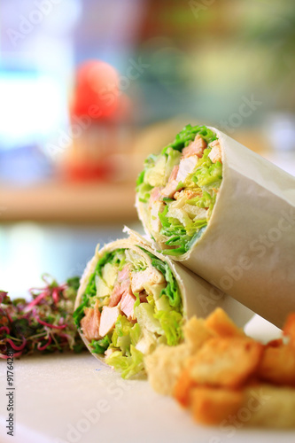 healthy wrap chicken and lettuce with salad and croutons on a side shot front on close-up and cropped portrait