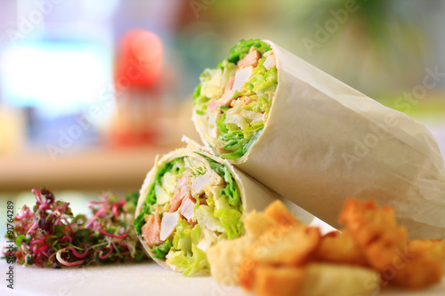 healthy wrap chicken and lettuce with salad and croutons on a side shot front on with blurred background landscape
