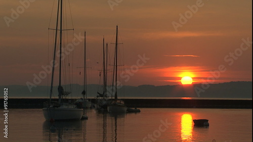 Anchored sailboat sunrise