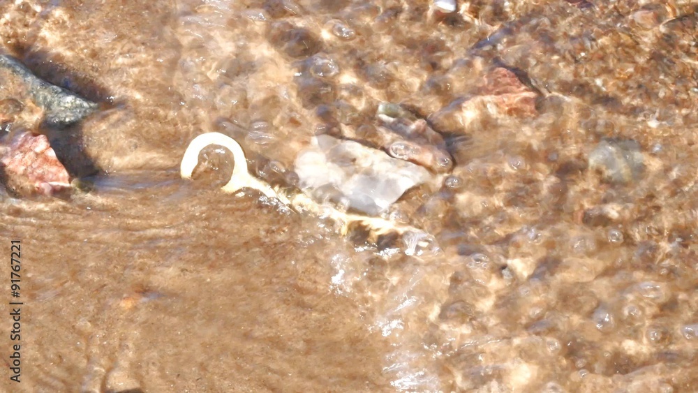 Partly Buried Brass Key In Sand With Water Flowing Over Stock Video ...