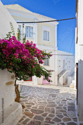 Street with traditional architecture in the old part of Parikia which is the capital and main port of Paros island in Greece.