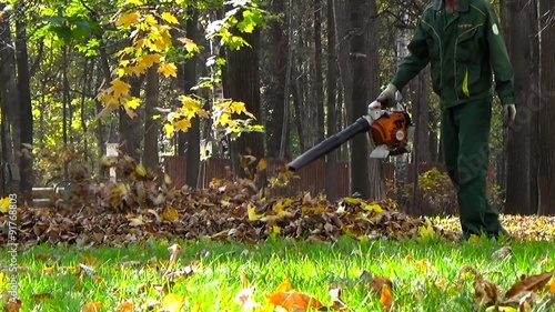 Gardener with a leaf blower in the park photo