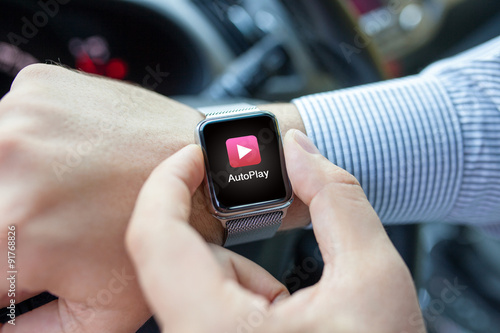 Man hand in the car watch and app auto play