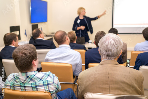 Business woman is speaking on conference.