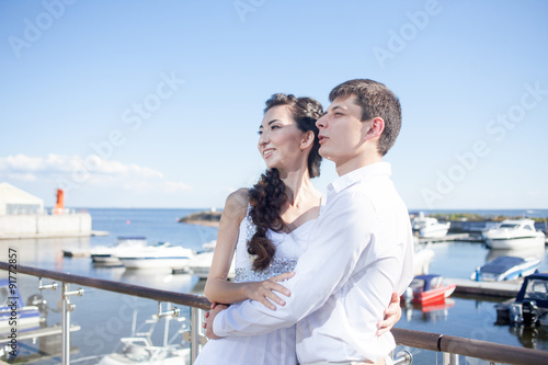 bride and groom on the background of yacht club, young happy