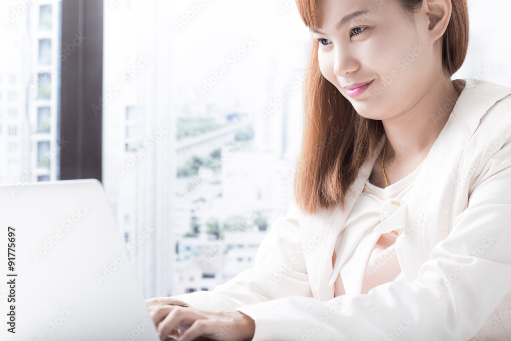 Business woman working on laptop computer at office Business woman working on laptop computer at office