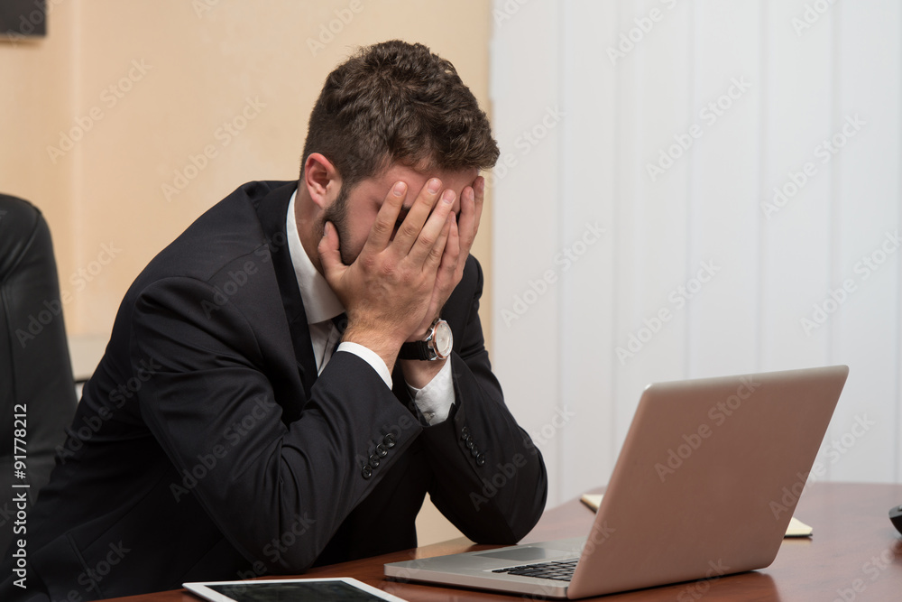 Young Business Man With Problems In The Office Young Business Man With Problems In The Office