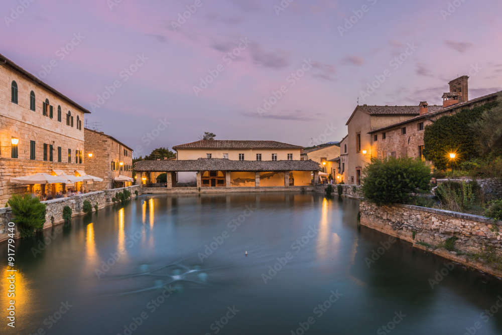 View on thermal bath in the medieval Tuscan town at dusk.