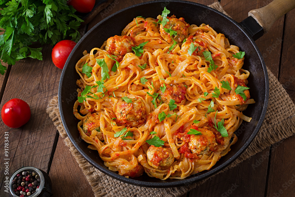Pasta linguine with meatballs in tomato sauce. Top view Pasta linguine with meatballs in tomato sauce. Top view