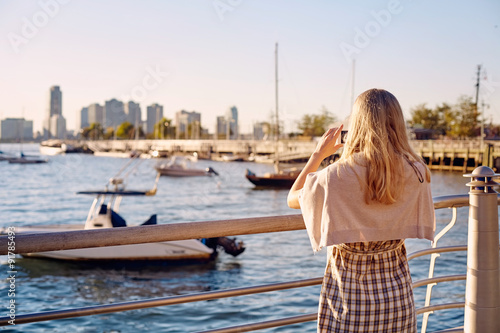 Woman photographing bay
