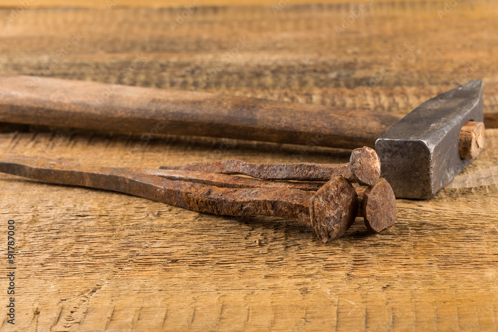 Fototapeta premium Vintage hammer with nails on wood background