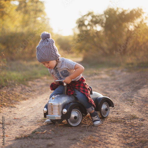 Toddler playing with toy car outdoors