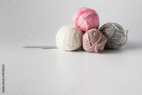 Clews of colored yarn with needle