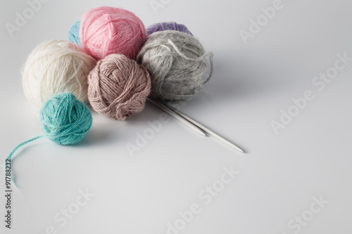 Clews of colored yarn with needle