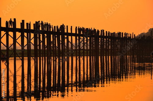 Amarapura, Myanmar - 14 March 2015: People walking on the wooden bridge of U Bein on river Ayeyarwad, Myanmar