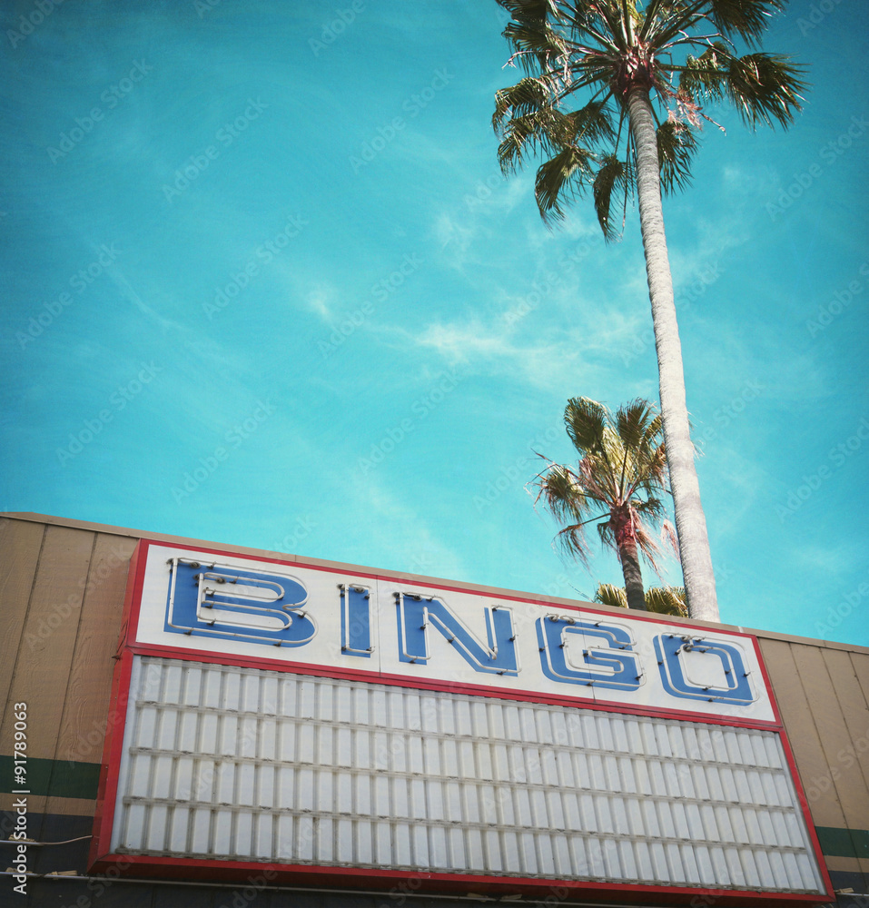 Obraz premium aged and worn vintage photo of bingo hall and palm trees