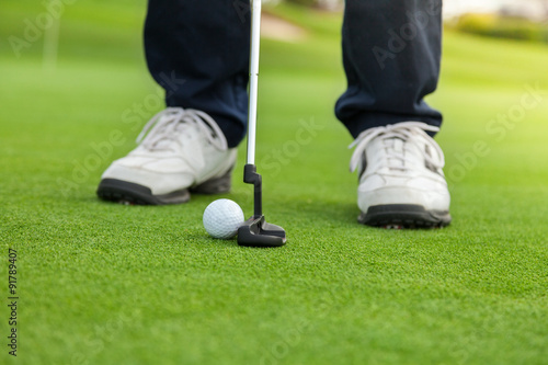 Golf player at the putting green